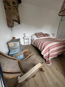 a bedroom with a bed and a rocking chair at Charming house in an old rectory PMR in Tréguier