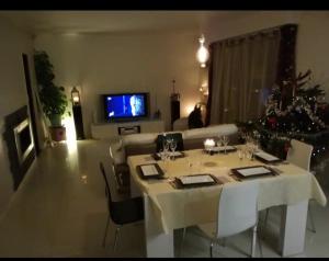 a living room with a table and a christmas tree at Porte de Paris in Saclay