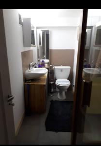 a small bathroom with a toilet and a sink at Porte de Paris in Saclay +2 photos