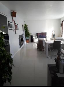 a living room with a couch and a table at Porte de Paris in Saclay