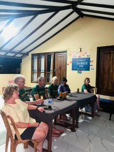 a group of people sitting at tables in a room at Sea Breeze Stay in Negombo
