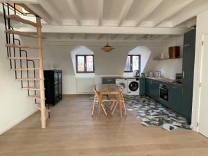 a kitchen with a table and a staircase in a room at Triplex de charme avec vue in Brussels