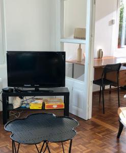 a living room with a television on a table at 10 Courchamp in Courchamp