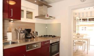 a kitchen with a sink and a stove top oven at Dat Witte Huuske in Emden