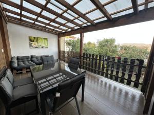 a balcony with a couch and a table and chairs at Palminas Monteur FeWo EG in Merzig