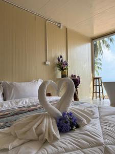 two swans are forming a heart on a bed at Sand Bara in Ban Pak Ba Ra +13 photos