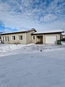a house with a lot of snow in front of it at Simple Cozy House in Raahe