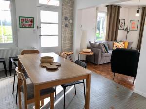 a living room with a table and a couch at 10 Courchamp in Courchamp +15 photos
