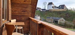 a balcony with a table and chairs on a house at Chata Seeberg in Poustka