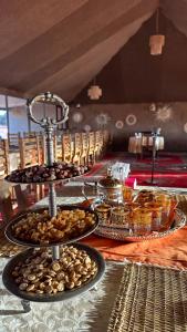 a table with a tray of food on top at Stellar Luxury Camp in Merzouga