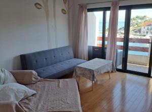 a living room with a couch and a table at Stomorska Seaside Apartments in Stomorska