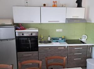 a kitchen with a sink and a stove top oven at Stomorska Seaside Apartments in Stomorska