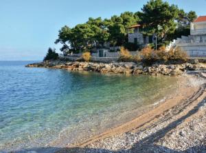 a house on the shore of a body of water at Stomorska Seaside Apartments in Stomorska +6 photos