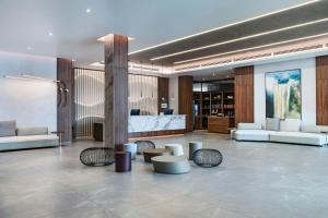 a lobby with couches and tables in a building at AC Hotel by Marriott Georgetown Guyana in Georgetown