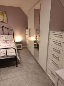 a bedroom with a bed and a large mirror at Hillview in Daliburgh