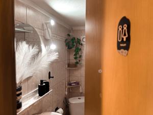 a bathroom with a toilet and a sign on the door at Aurora Luxury Apartment in Keramoti +33 photos