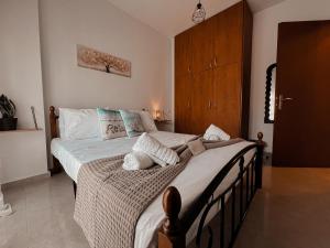 a bedroom with a large bed with white sheets at Aurora Luxury Apartment in Keramoti