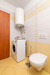 a bathroom with a washing machine and a toilet at Apartments Manuela in Pula +42 photos