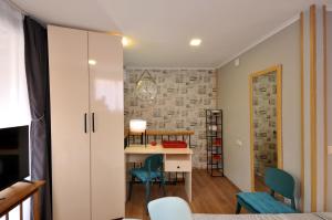 a small room with a desk and chairs at Cottage at Chavchavadze in Tbilisi City