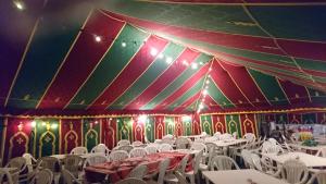 a room with white tables and chairs in a tent at Les Maisons De Chante Oiseau, Maisons, Lodges, Tentes et Cabane in Sigonce +71 photos