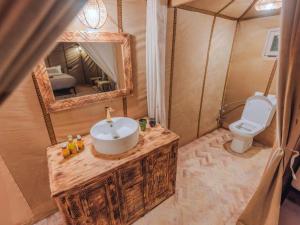 a bathroom with a sink and a toilet at Stellar Luxury Camp in Merzouga