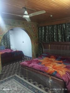 a bedroom with a large bed in a room with a ceiling at New shalimar dal view in Srinagar