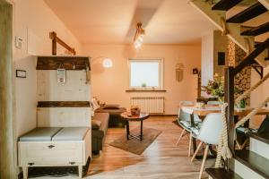a living room with a table and a dining room at Domek na Przylasku in Grywałd