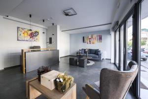 a living room with a couch and a table at Antheon Suites Volos in Volos