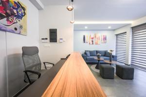 a living room with a table and a couch at Antheon Suites Volos in Volos