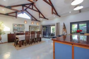 a kitchen and dining room with a table and chairs at White Sparrow Villa in Marloth Park
