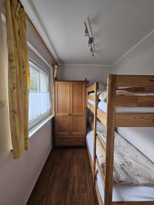 a room with two bunk beds and a window at Haus am Waldesrand in Wustrow
