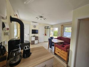 a kitchen and a living room with a stove at Haus am Waldesrand in Wustrow