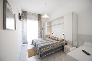 a bedroom with a bed and a large window at Hotel Gigliola in Bellaria-Igea Marina +15 photos