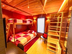 a room with a bed and bunk beds in it at Chalet urbain-150m2 jardin privatif-15mn de Paris in Le Bourget