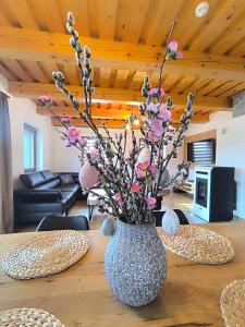 a vase with flowers sitting on a table at Chata Valeriana Liptov in Ižipovce +50 photos