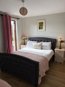 a bedroom with a large bed with two night stands at Sea Breeze B&B in Clonakilty