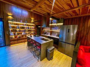 a kitchen with a refrigerator and a counter top at Chalet urbain-150m2 jardin privatif-15mn de Paris in Le Bourget