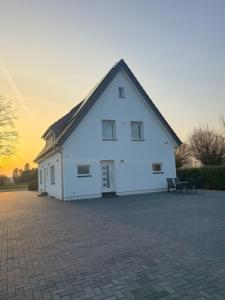 a large white building with a black roof at SR Ferienwohnung Wagenfeld in Wagenfeld