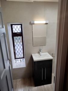 a bathroom with a sink and a window at Aran View Loft in Knockfin Cross Roads +8 photos