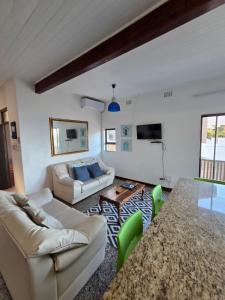 a living room with a couch and a table at Ocean rush barracuda in Zinkwazi Beach