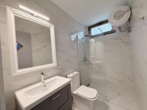 a bathroom with a toilet and a sink and a shower at Cassa Luca in Glarokavmos in Paliouri +19 photos