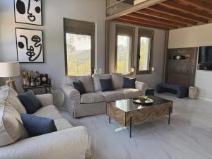 a living room with two couches and a coffee table at Cassa Luca in Glarokavmos in Paliouri