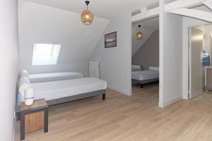a white room with a bed and a table at L 'Escale Morvandelle in Saint-Brisson
