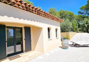 a patio outside of a house with a bench at Suite Sieste en Provence in Entrecasteaux +6 photos