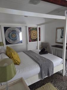 a bedroom with a white bed with yellow pillows at Ocean Rush in Zinkwazi Beach