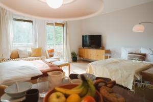a bedroom with a bed and a table with a bowl of fruit at Studio5 am Ringpark in Würzburg