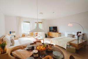 a large living room with a bed and a table at Studio5 am Ringpark in Würzburg