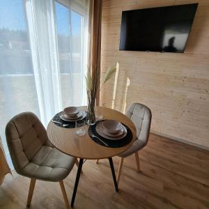 a dining room with a table and two chairs at Leśny Reset 2 in Grabowo