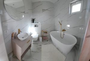 a white bathroom with a sink and a toilet at Leśny Reset 2 in Grabowo +15 photos