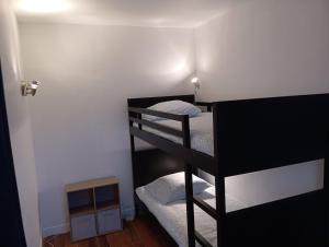 a room with three bunk beds in a room at Magnifique et Grand T3 au cœur de la Normandie in Saint-Victor-lʼAbbaye